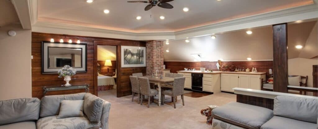 A cozy, modern open-concept living area featuring a kitchen, dining space, and comfortable seating.