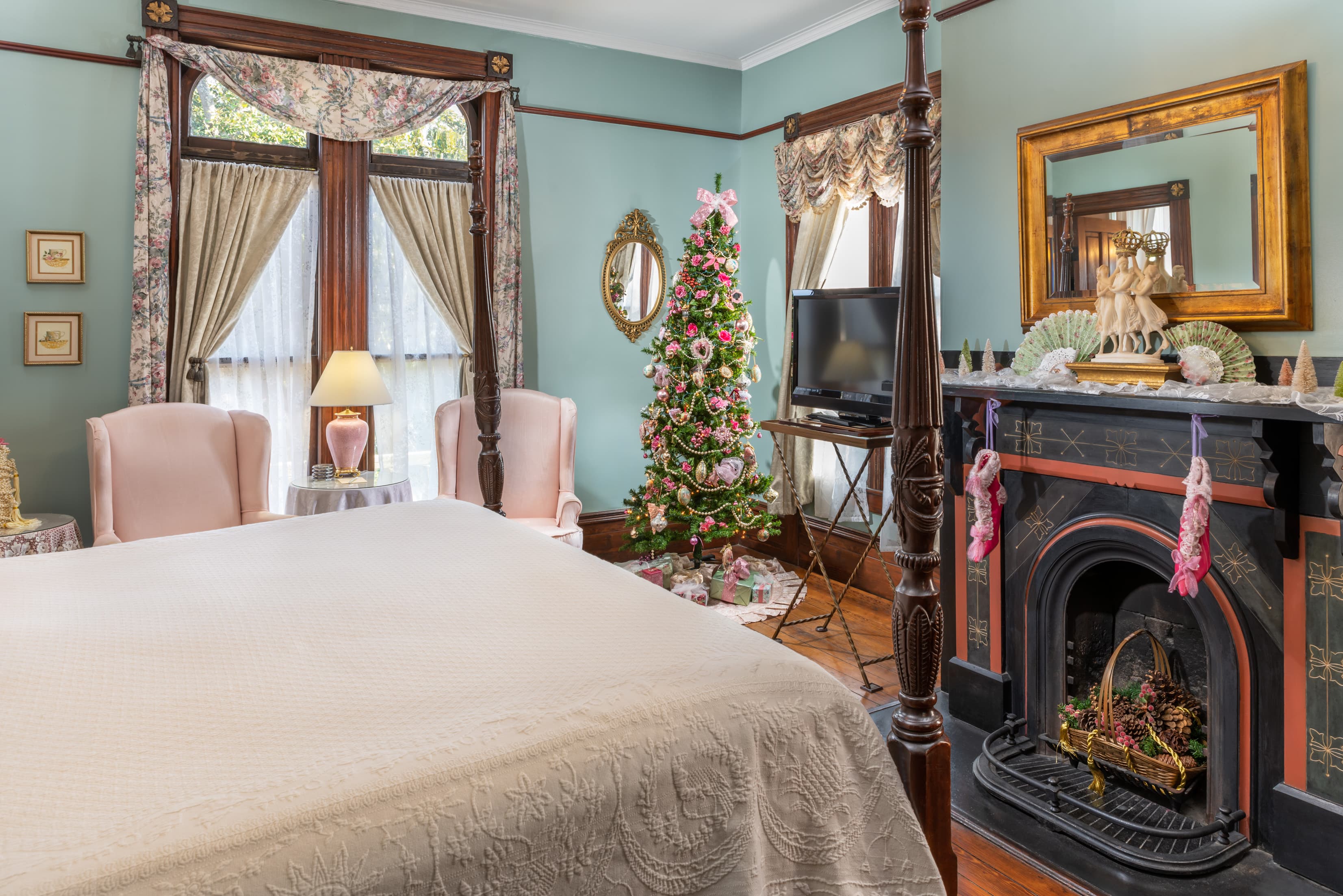 Festively decorated guest suite with Christmas tree and fireplace