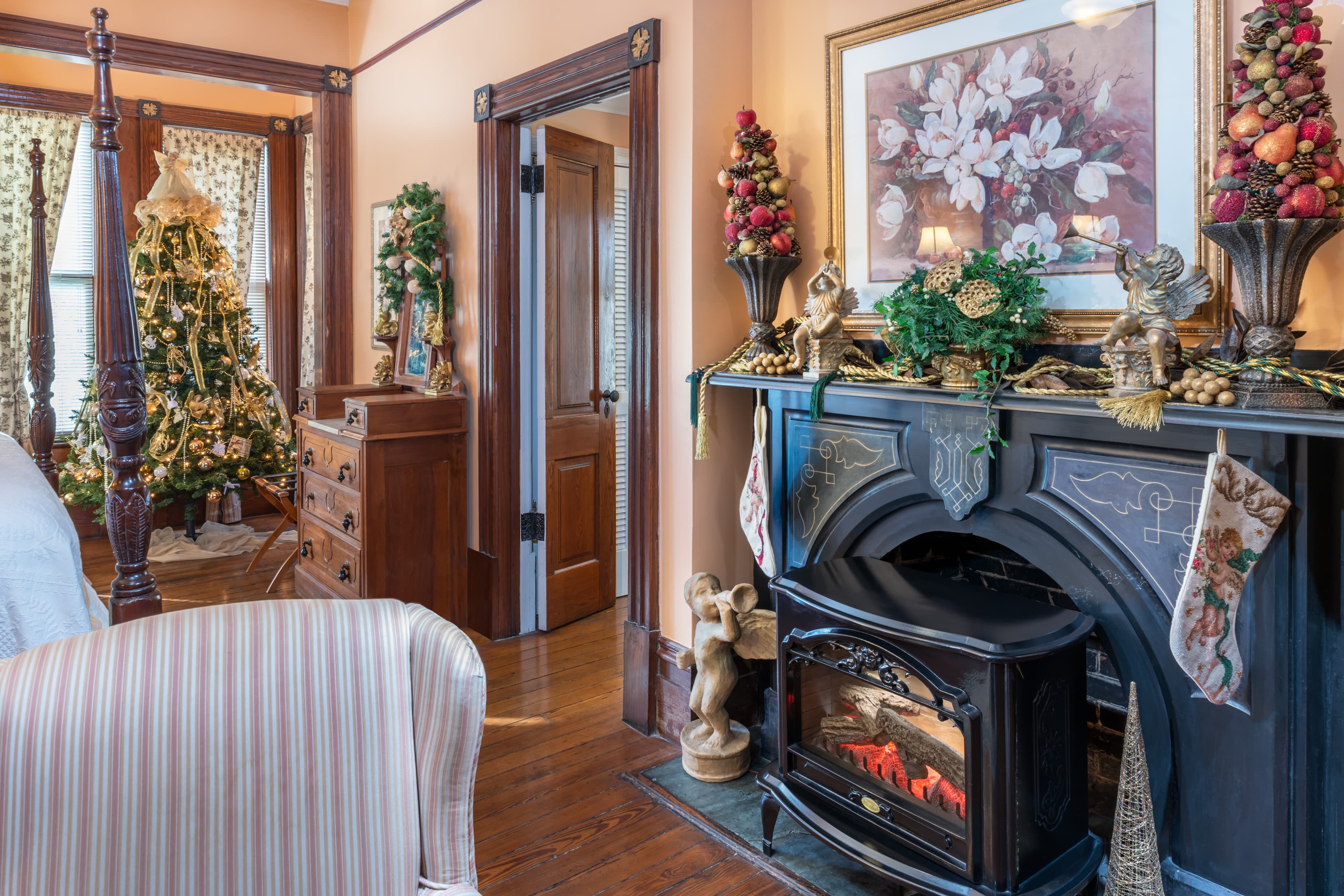 Festively decorated guest suite with fireplace and Christmas décor