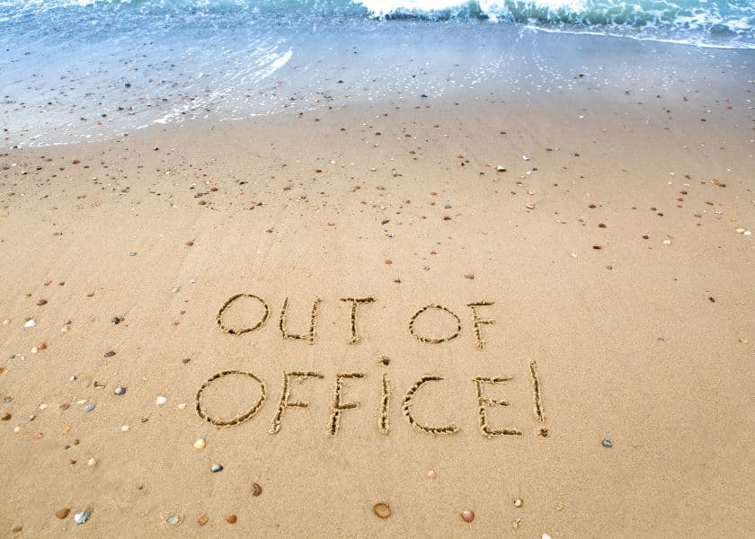 Sand with the phrase "OUT OF OFFICE!" written in it, near the shoreline. Sand with the phrase "OUT OF OFFICE!" written in it, near the shoreline.