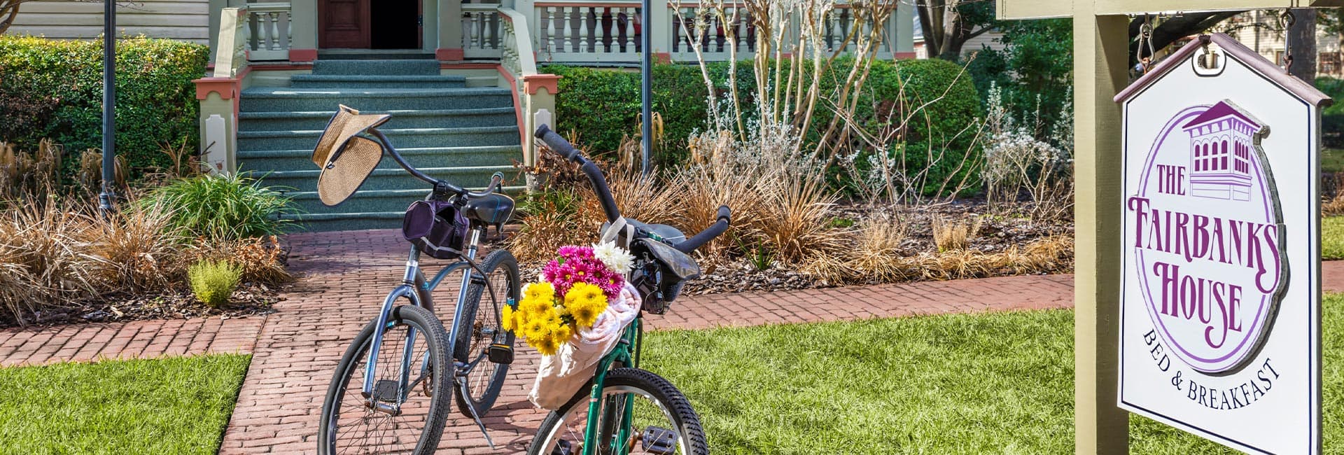 Bicycles with flowers parked in front of The Fairbanks House bed and breakfast.